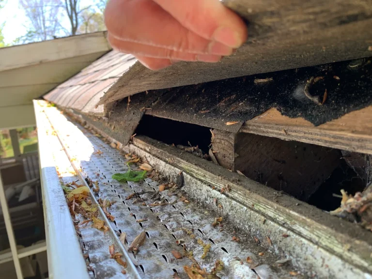 roofing damage shown at the gutters by a BTB construction team member in this close up photograph